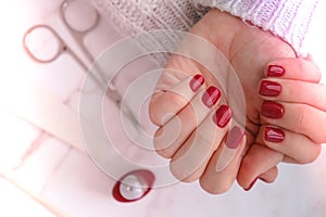 Stylish red female nails. Modern Beautiful manicure. Autumn winter nail design concept of beauty treatment. Gel nails