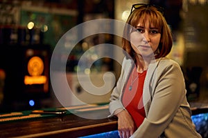 Stylish Redhead Woman Enjoying a Cozy Bar Moment