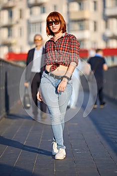 Stylish Redhead Woman in Urban Autumn Fashion. Smiling