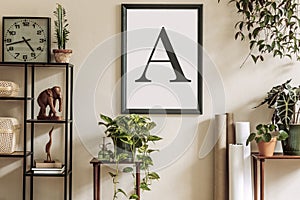 Stylish retro home staging of living room with black mock up poster frame, design furnitures, a ot of plants, clock, rattan boxes. photo