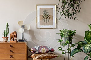 Stylish retro home staging of living room with gold mock up poster frame. photo