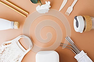 Stylish reusable eco friendly items on brown background