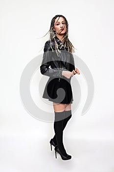 Stylish rock n roll ballerina girl with blonde braids posing in studio on isolated background. Style, trends, fashion concept.