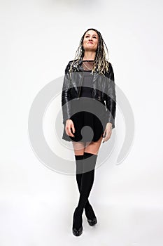 Stylish rock n roll ballerina girl with blonde braids posing in studio on isolated background. Style, trends, fashion concept.