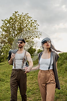 Stylish romantic couple in newsboy caps