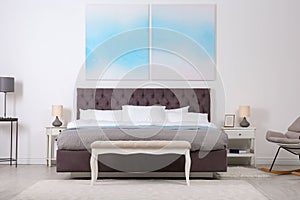 Stylish room interior with large comfortable bed