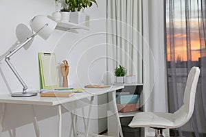 Stylish room interior with workplace near window. Design idea
