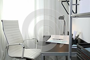 Stylish room interior with workplace near window. Design idea