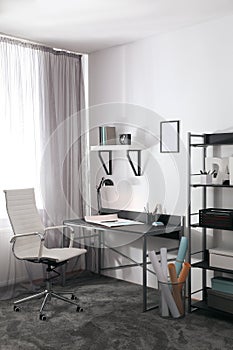 Stylish room interior with workplace near window. Design idea