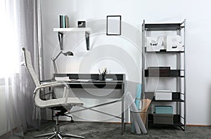 Stylish room interior with workplace near window. Design idea