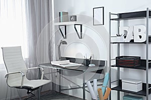 Stylish room interior with workplace near window. Design idea