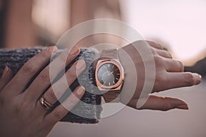 Stylish rose gold watch on woman hand, close-up