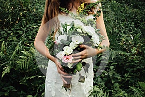 Stylish rustic bouquet in the hand of gorgeous boho bride on the