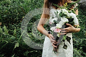 Stylish rustic bouquet in the hand of gorgeous boho bride on the