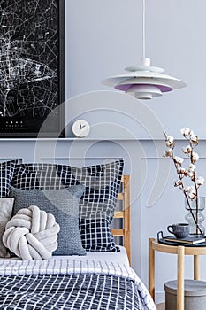 Stylish scandinavian bedroom interior with design coffee table, mock up poster frames, book, clock, decoration.