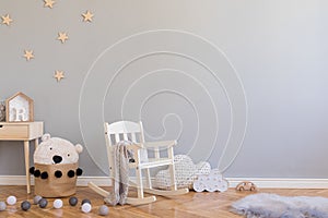 Stylish scandinavian kid room with copy space, toys, teddy bear, plush animal and children accessories. Modern interior.