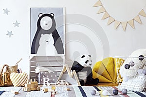 Stylish scandinavian kid room with mock up poster, toys, teddy bear, plush animal, natural pouf and children accessories.