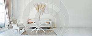 Stylish Scandinavian modern white cozy eco interior in minimalist style. Modern home decor with Pampas grass in vase. Open space.