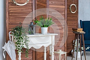 Stylish scandinavian room with wooden Console table, and beautiful plants. Design composition of home interior.Still