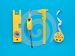 Stylish set of yellow measuring instrument on a blue background. Minimal concept of measuring instruments