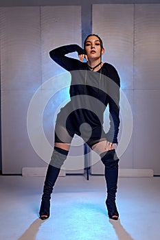 stylish sexy woman dancing alone in smoky blue lighted background. woman dancer.