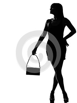 Stylish silhouette woman waiting holding purse