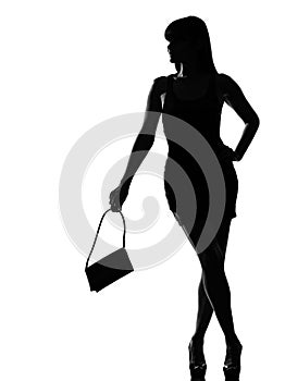 Stylish silhouette woman waiting holding purse