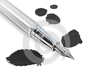 Stylish silver fountain pen and blots of ink on white