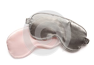 Stylish sleep masks on white background