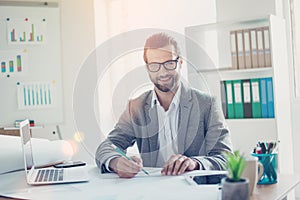 Stylish smiling architect in formal wear has ideas and working w photo