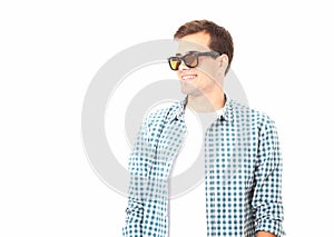 Stylish smiling guy. Cheerful young handsome man in sunglasses and looking away with smile. Copy space. Mock up. Summer