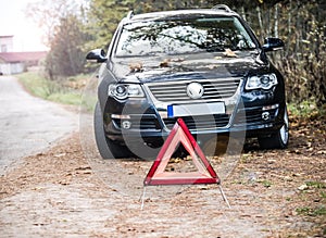 Stylish sport car and warning sign