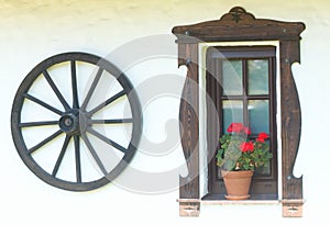 Stylish still life with a wheel and a window with flowers