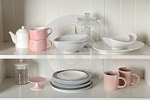 Stylish storage stand with different ceramic dishware