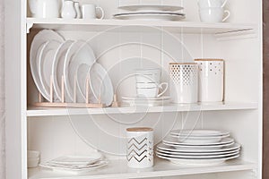 Stylish storage stand with different ceramic dishware