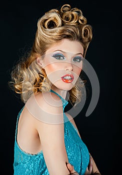 Stylish studio portrait of a beautiful young woman. Close up lady. Beautiful blonde woman in blue dress. Pin up style