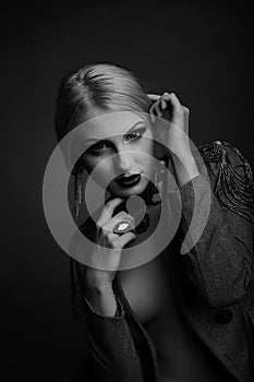 Stylish studio shot of a magnificent model wears jacket on a naked body