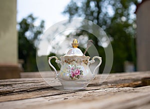 Stylish sugar bowl on a romantic background photo