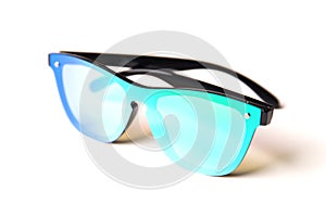 Stylish sunglasses with mirror blue-green lenses isolated on white background