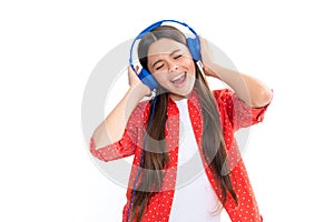 Stylish teenage girl listening to music with headphones. Kids lifestyle concept. Wireless earphones. Portrait of
