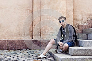 Stylish teenager resting on the stairs steps