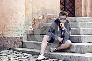 Stylish teenager resting on the stairs steps