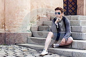 Stylish teenager resting on the stairs steps