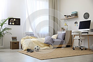 Stylish teenager`s room interior with bed and workplace