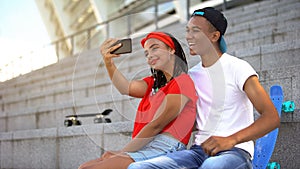 Stylish teenagers taking selfie on smartphone, youth subculture, entertainment