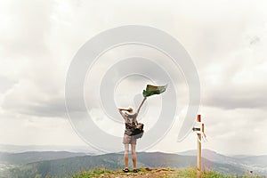 Stylish traveler hipster woman with backpack holding map into s