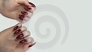 Stylish trendy red female manicure.Hands of a woman with red manicure on nails