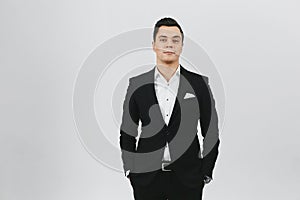 Stylish trendy young brunette man a in white shirt and black suit on white background