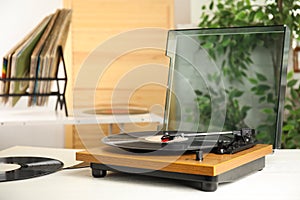 Stylish turntable and vintage vinyl records indoors