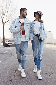 Stylish vintage young couple walking on the road